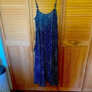 Grey and white dot print strapped dress with ruffled hem.